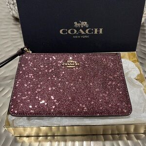 New Coach Wristlet in Beautiful Burgundy Star Glitter comes with gift box.